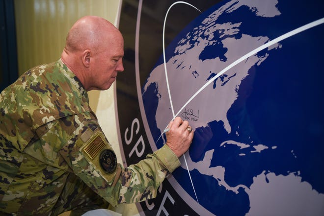 General John Raymond, U.S. Space Force chief of space operations, signs the United States Space Command sign inside of the Perimeter Acquisition Radar building Jan. 10, 2020, on Cavalier Air Force Station, North Dakota. Raymond toured inside the PAR building, where he learned first-hand how operations work inside the facility and listened to Airmen’s suggestions.