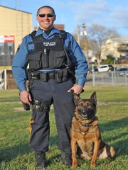 Millville Police are mourning the loss of K-9 Chase, pictured here with his partner Officer Michael Calchi on Dec. 18, 2014. File photo