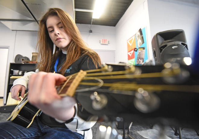 McKenna Stoffer, 17, an Ontario junior, attending Pioneer Performing Arts, practices guitar Tuesday morning at Theatre 166 building.
