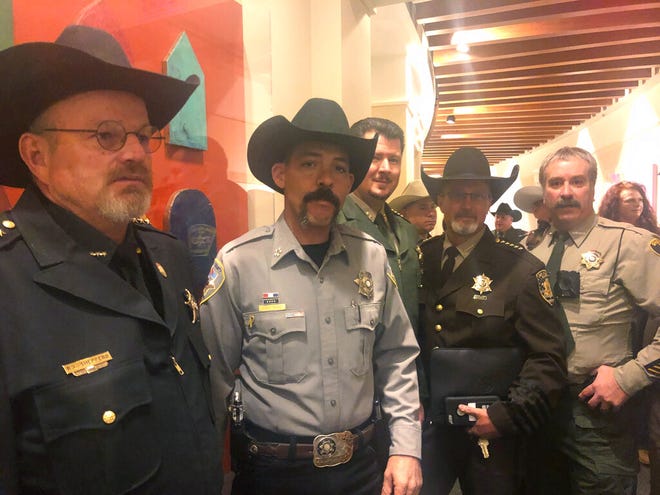 A group of New Mexico sheriffs stand outside the New Mexico Senate in Santa Fe, N..M., on Tuesday, Jan. 28, 2019, before a committee debates proposals on gun control and legalizing marijuana.