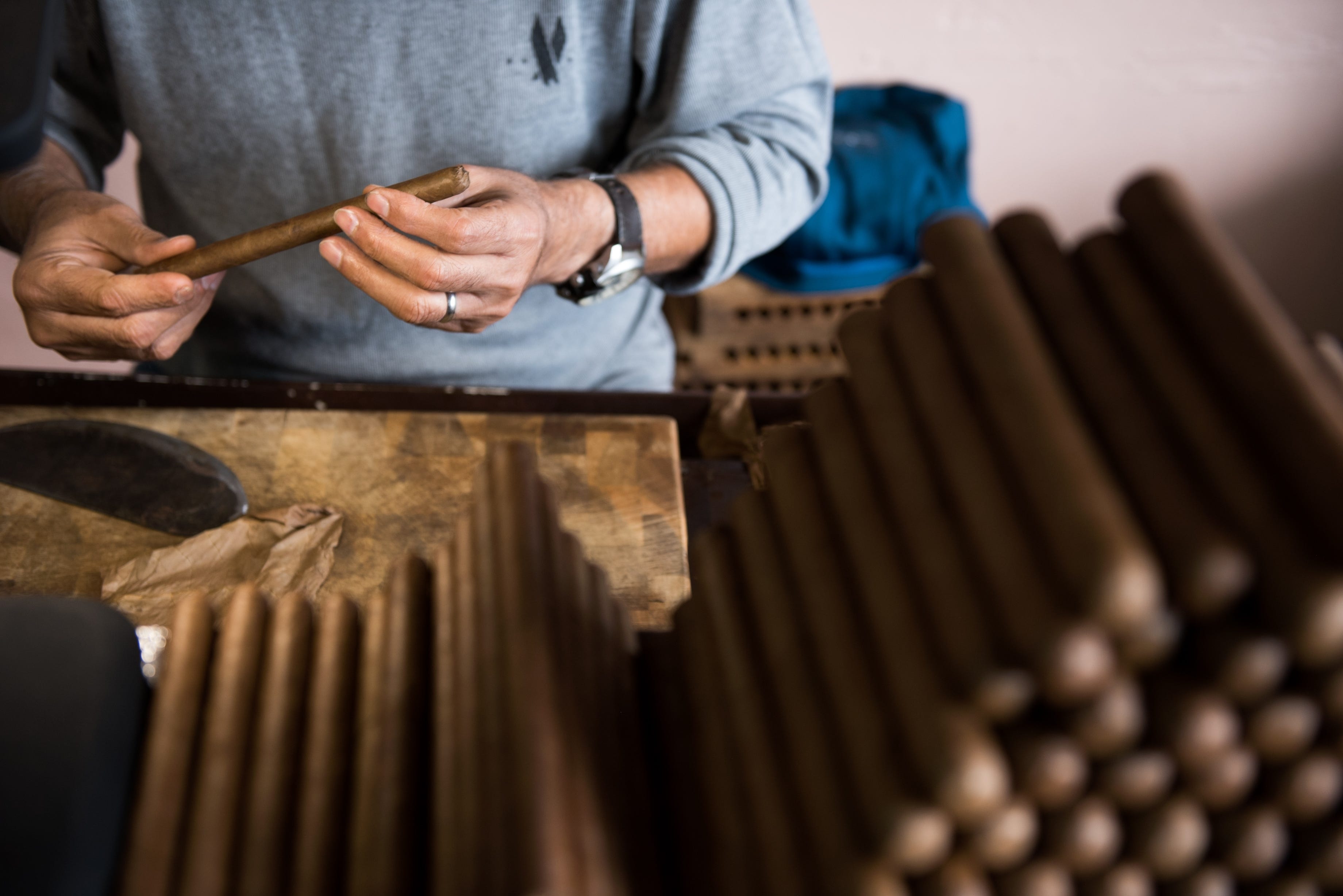 Rodolfo Amaro Beltrán, a native Cuban, feels out the size of a handmade cigar at Casa del Tabaco in Little Havana.