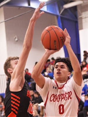 Cooper's Josh Henry (0) shoots over Aledo's Chase Becker in the second half. Cooper beat the Bearcats 60-40 in the District 4-5A game Tuesday, Jan. 28, 2020, at Cougar Gym.