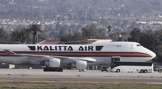 Personnel in hazmat suits are seen in the cargo hold of the Kalitta Air Boeing 747-400 freighter at the March Air Reserve Base after deplaning 200 American evacuees in Riverside, California Jan. 29, 2020. The plane left Wuhan, epicenter of the coronavirus epidemic, to Anchorage, Alaska, to refuel and screen the passengers before departing for March Air Reserve Base where the evacuated U.S. citizens will be taken care of by the CDC.