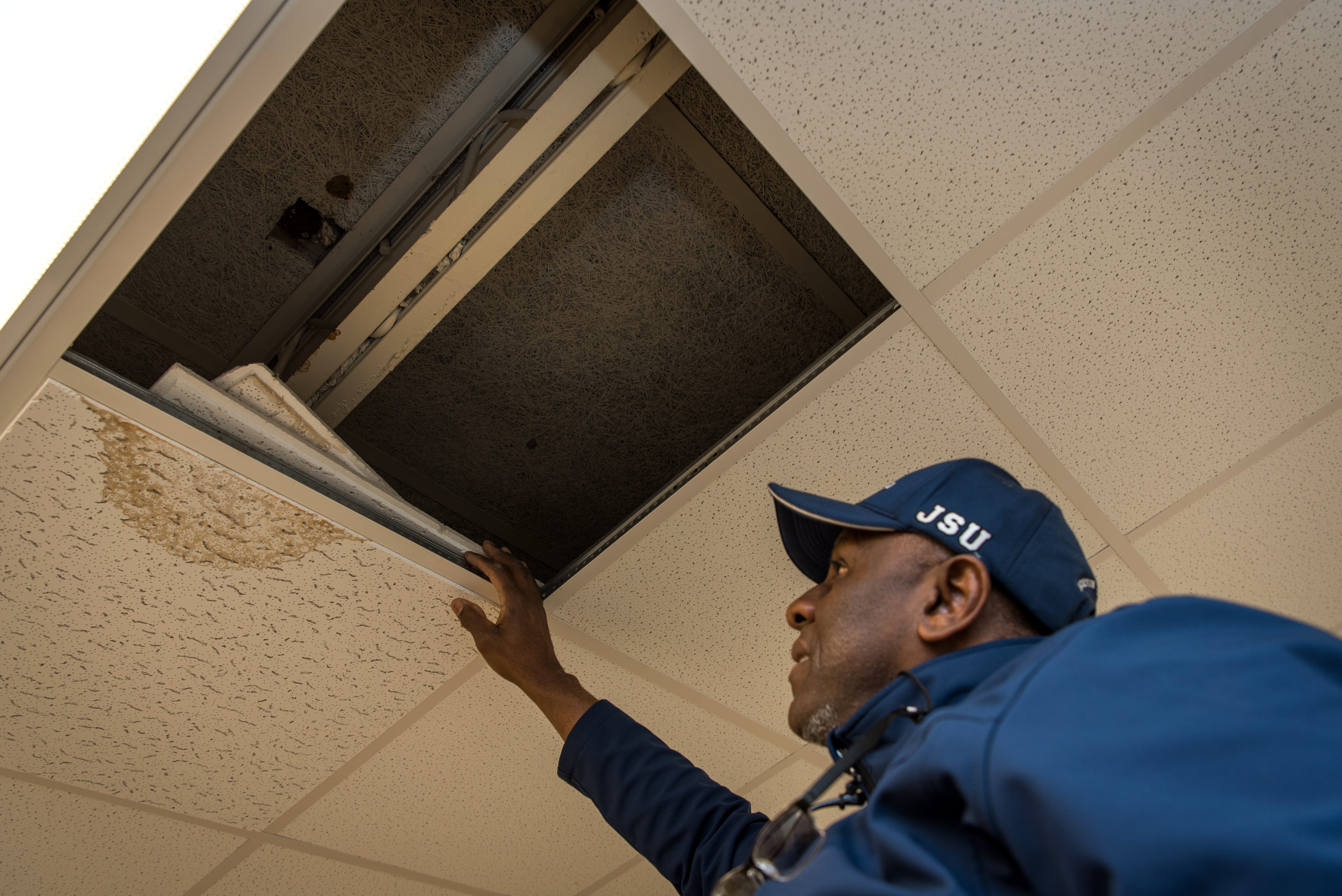 Holmes County Consolidated School District maintenance manager Alonzo Washington points out ceiling damage at Williams-Sullivan Middle School in Durant.