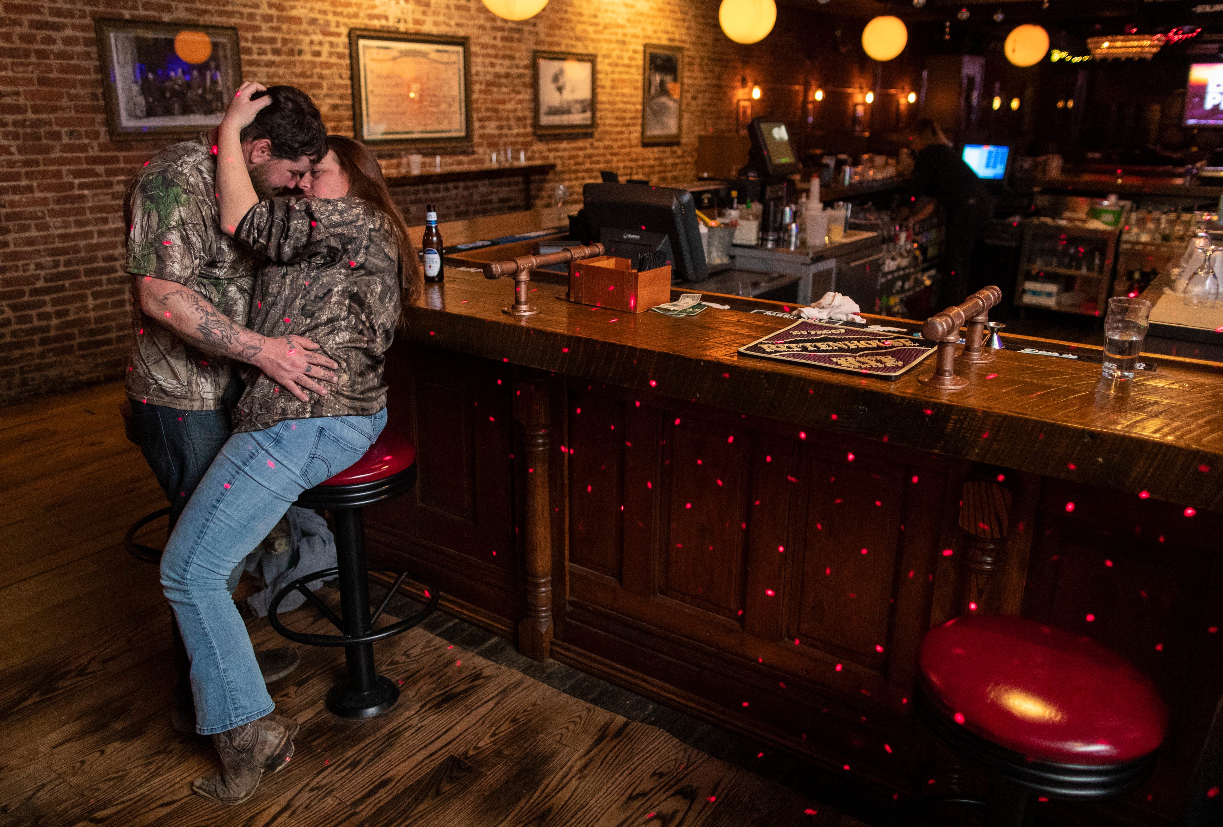 Andrew Williams, left, and Amber Ritter pull each other close after a late night for karaoke at O'Shea's in downtown Louisville on Jan. 26, 2020. "I've come to be good friends with DJ Michael Lawson," Williams said. "I stumbled in here one night and I heard some off-key music and I've been coming here ever since."