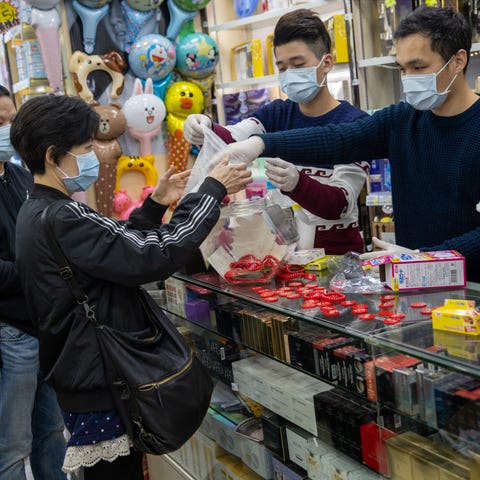 People line up to receive free face masks to prote