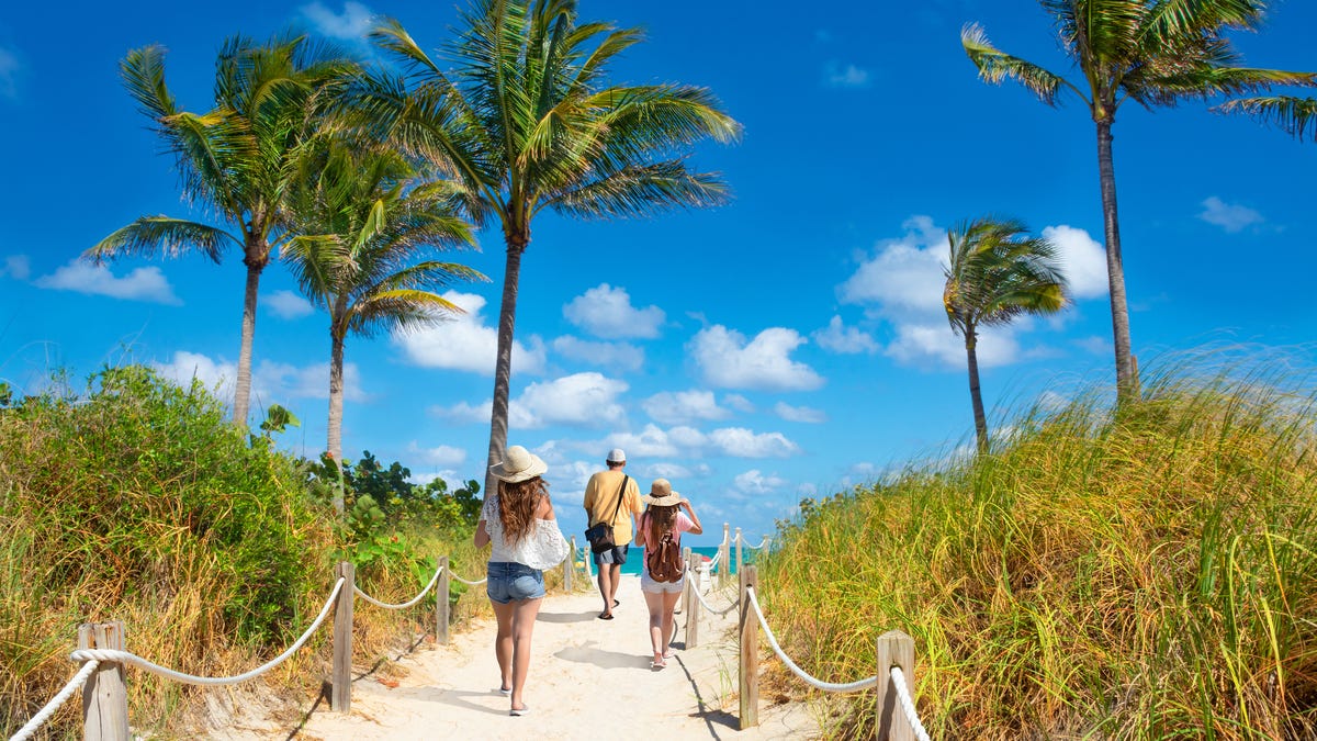 People enjoy time on the beach at South Beach in Miami.