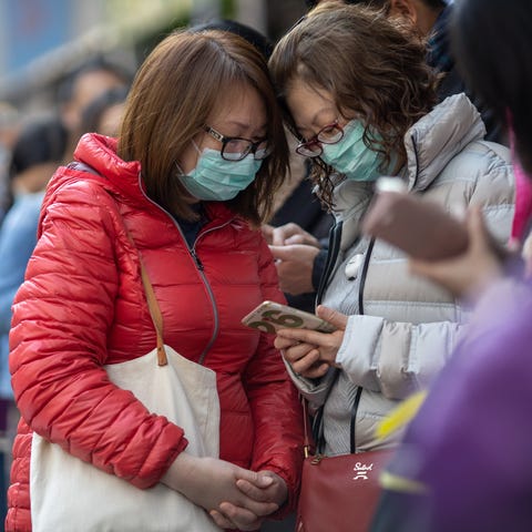 People line up to receive free face masks to prote