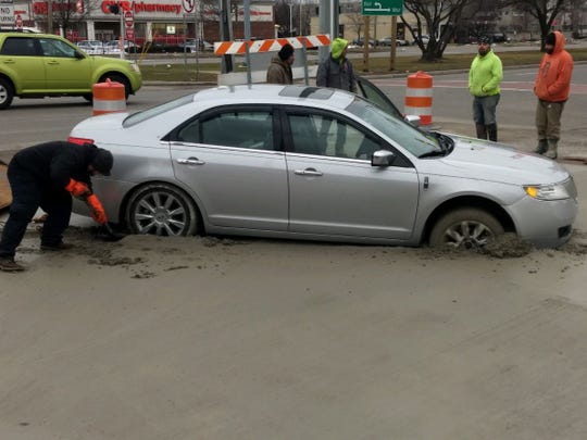 Officials with the Road Commission for Oakland County said a motorist drove around construction barricades and into freshly poured concrete.
