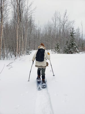 Jon Michels snowshoes through his land on the west side of the Red Cliff Reservation near the Apostle Islands National Lakeshore on the Bayfield peninsula.