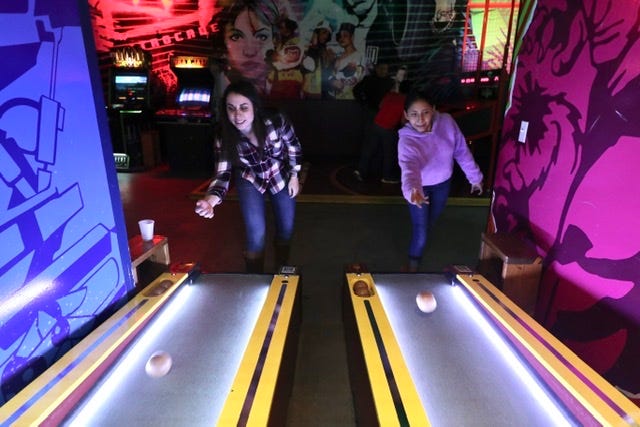 Shelby Castello and Raquel Torres with Big Brothers, Big Sisters Play Skee Ball at Rad Retrocade in Downtown in Las Cruces to celebrate National Mentoring Month in 2020.