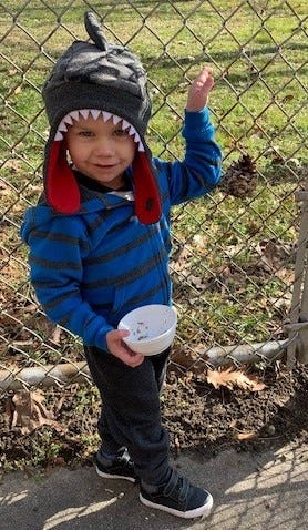 Jonah Nichols, 2, of Upper Deerfield, poses with the peanut butter and bird seed pinecone he made during a Wee Read Program at Cumberland County Library. The library is at 800 E. Commerce St., Bridgeton. For information, call (856) 453-2210.