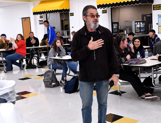 George Orosco, lead custodian at Abilene High School, is surprised in the cafeteria by Superintendent David Young and others Friday Jan. 31, 2020. Orosco was one of three in the district presented with the IMPACT Award, which recognizes employees who make exceptional efforts for making experiences on their campuses positive and memorable. Others honored Friday were Elaine Herwick, nurse at Taylor Elementary School, and Amber West, Bowie Elementary library assistant. They will be honored together at the Feb. 10 meeting of the AISD board of trustees.