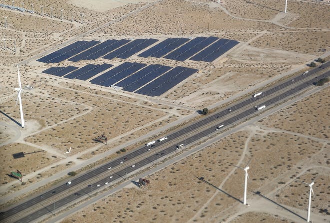 I-10 traffic drives between solar panels and windmills in Palm Springs in this aerial photo, January 12, 2020.