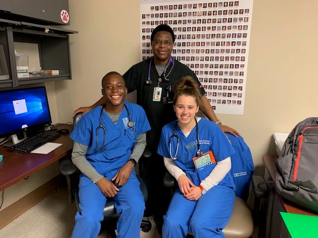Abdul Tholley and Samantha Reese, front, pose with their clinical teaching partner, Augustin Harelimana, RN, at Valleywise Health Medical Center while students in Creighton University's accelerated nursing program in Phoenix. Tholley and Reese graduated from the program in 2019 and are now practicing registered nurses.