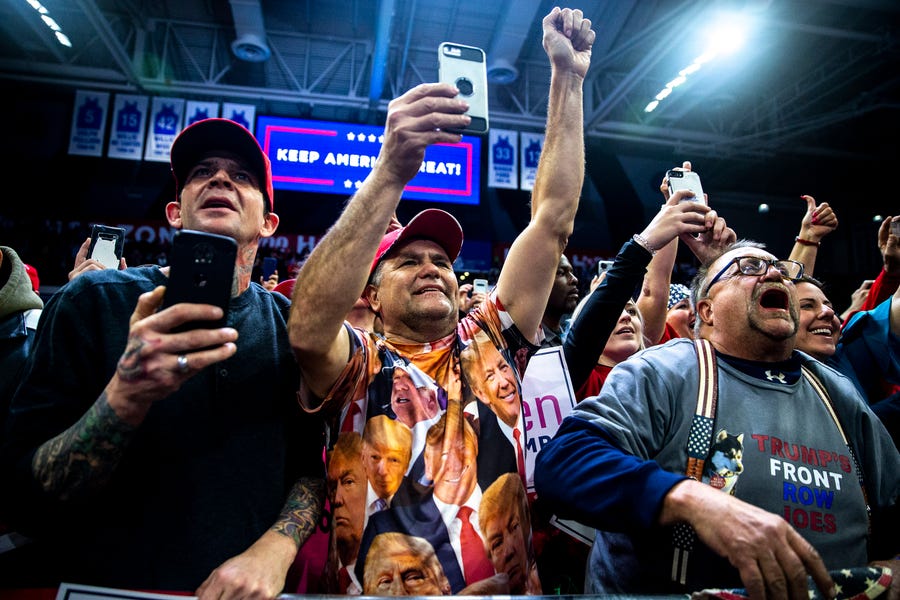 People in the crowd cheer for President Donald Trump as he arrives at the Knapp Center for a campaign rally on Thursday, Jan. 30, 2020, in Des Moines. 