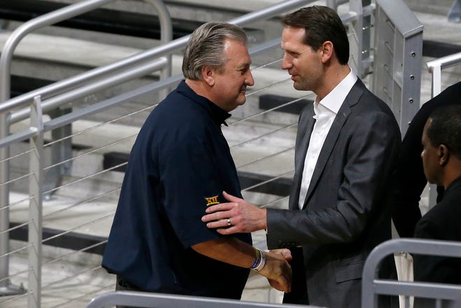 Former Bearcats basketball coach Bob Huggins talks with current coach John Brannen during a memorial service for former University of Cincinnati basketball player, coach and broadcaster Chuck Machock at Fifth Third Arena in Cincinnati on Friday, Jan. 31, 2020.