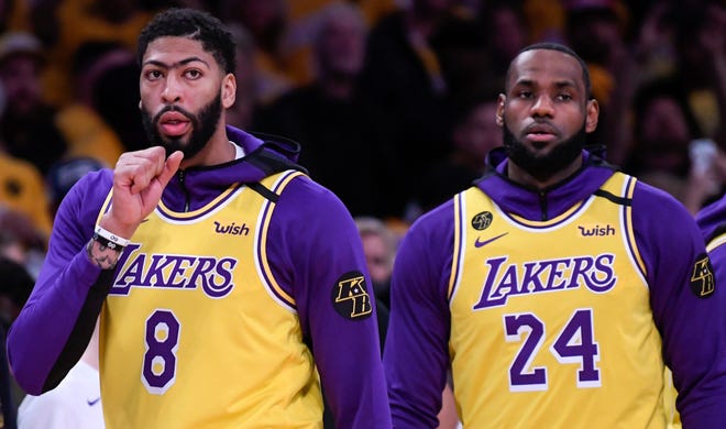 Anthony Davis and LeBron James wear uniform numbers worn by longtime Lakers player Kobe Bryant during pregame warmups.