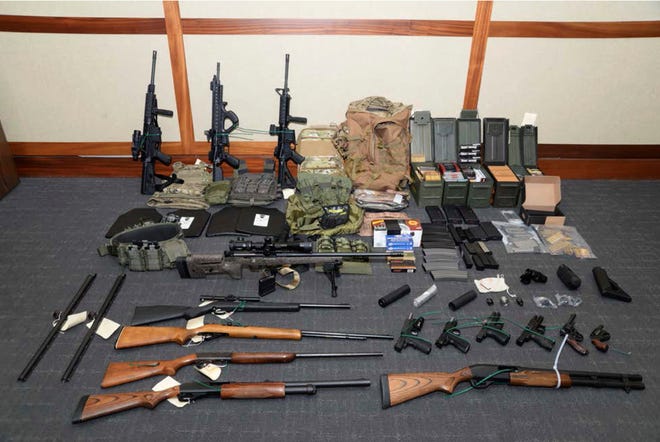 FILE - This undated file image provided by the Maryland U.S. District Attorney's Office shows a photo of firearms and ammunition that was in the motion for detention pending trial in the case against Christopher Hasson.  The Coast Guard lieutenant accused of stockpiling guns and drawing up a hist list of prominent Democrats and TV journalists is scheduled to be sentenced on Friday, Jan. 31, 2020 for his guilty plea to firearms and drug offenses. (Maryland U.S. District Attorney's Office via AP, File) ORG XMIT: MDPD101