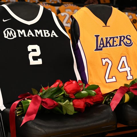 Roses and the jerseys of Kobe Bryant and his daugh