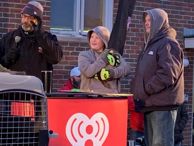 Paul James, left, of iHeartMedia Marion prepares to announce Buckeye Chuck's official forecast for Groundhog Day 2020. Chuck did not see his shadow on Sunday and is predicting an early spring for Ohio. Buckeye Chuck's handlers from Kokas Exotics of Prospect had Chuck on stage as James read the forecast.