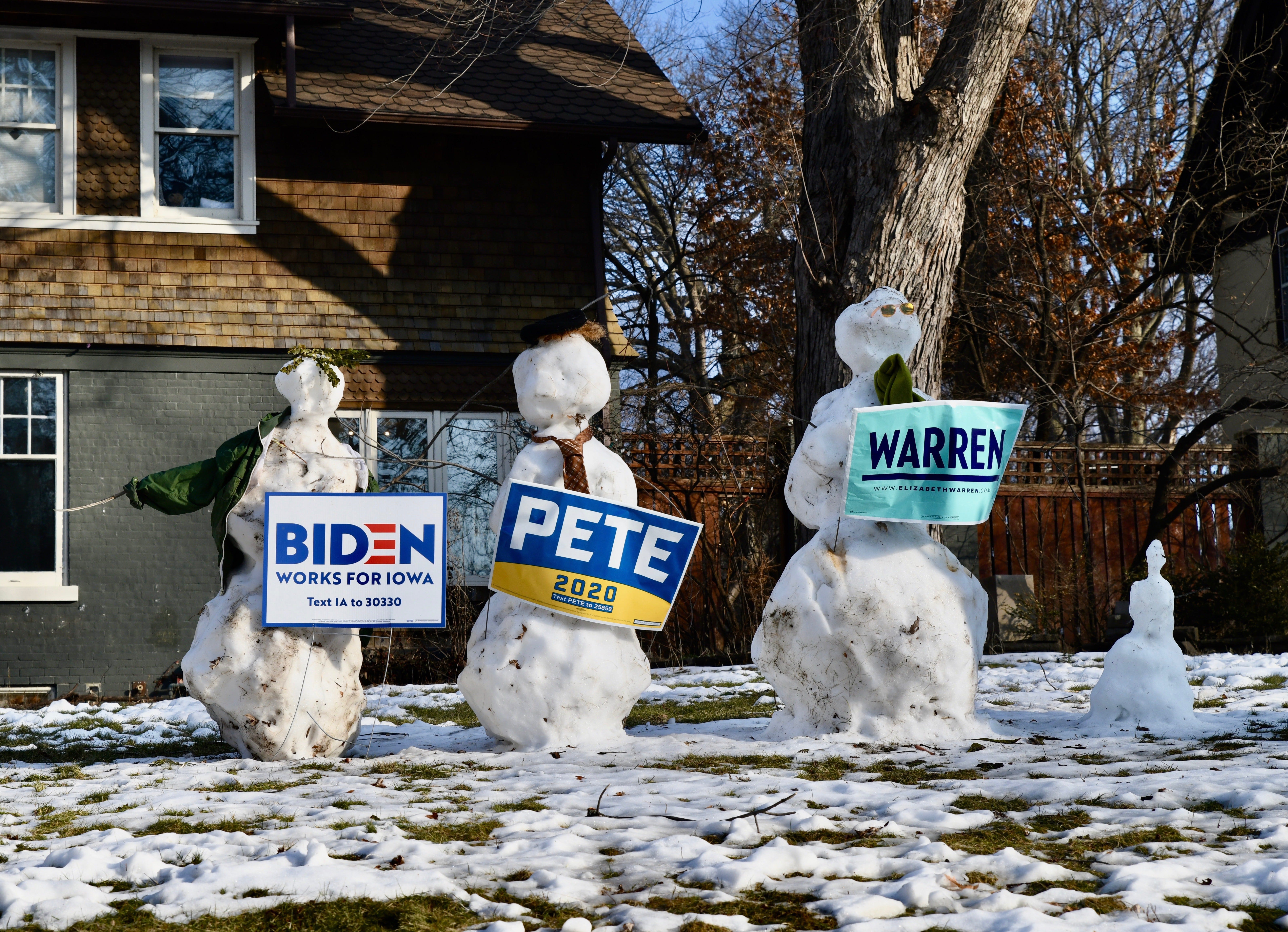 Snowmen dressed as Democratic presidential candidates former Vice President Joe Biden, left, former South Bend, Indiana, Mayor Pete Buttigieg and U.S. Sen. Elizabeth Warren of Massachusetts stand guard in one Des Moines yard.