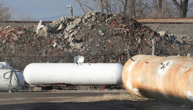 Looking through the lot of Motor City Propane at debris pilled on the property of Smalley Construction on Sunday, February 2, 2020 in Detroit, Mich.