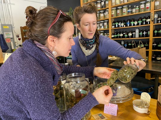 Jessilyn Dolan, left, of the Vermont Cannabis Nurses Association brings in her certified "clean, green" hemp product to be sold at Railyard Apothecary in Burlington in February 2020.