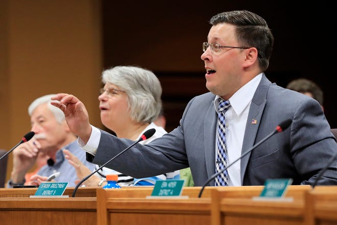 In this May 17, 2017 photo, Brown County Supervisor Staush Gruszynski speaks at a Brown County Board of Supervisors meeting at City Hall in Green Bay, Wis. Now a Wisconsin state Rep.,  Grusznyski, in December, was removed from committee assignments and the Democratic caucus after an investigation determined he "verbally sexually harassed" a legislative employee at an offsite location after work hours. He has rejected calls to resign.