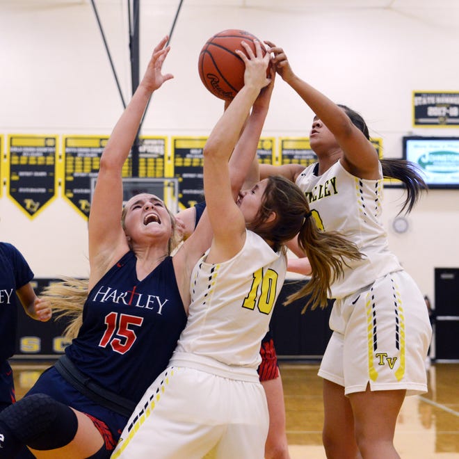 Hartley's Kami Kortokrax, left, fights for a rebound with Tri-Valley's Hannah King and Kyndal Howe during Tri-Valley's 57-33 win against visiting Columbus Hartley on Monday night in Dresden.