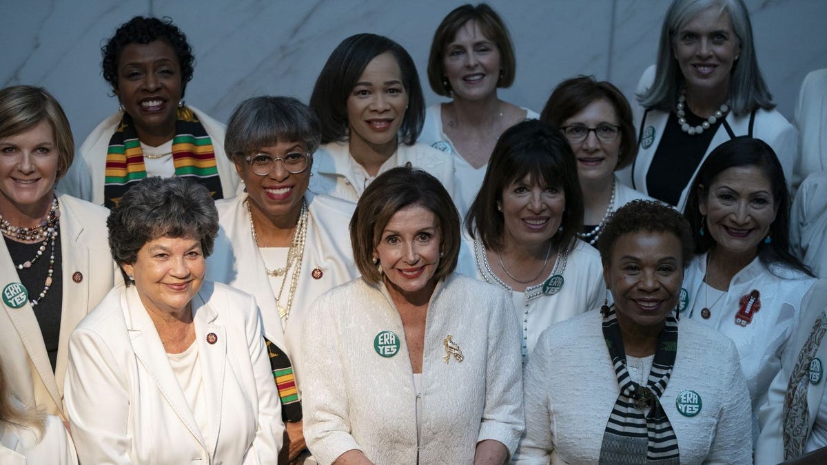 House Speaker Nancy Pelosi, D-Calif., poses for a group photo with members of the Democratic Women's Caucus prior to the State of the Union address at the U.S. Capitol on Tuesday.