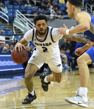 Nevada's Jalen Harris drives against Air Force's Sid Tomes during Tuesday's game. Harris broke the 30-point barrier for the third straight game.