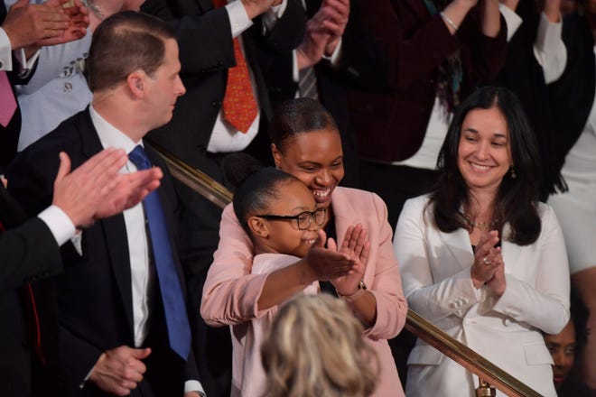 Stephanie and Janiyah Davis are applauded as they sit in the First Lady's box as  President Donald J. Trump delivers the State of the Union address from the House chamber of the United States Capitol in Washington. 