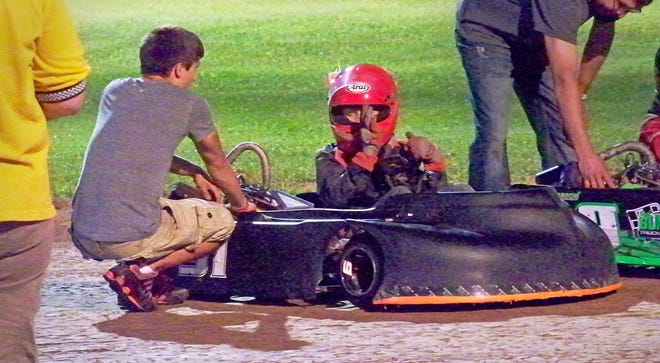 An 11-year-old Derek Kraus gets help from Ty Majeski with his go-kart in 2013.