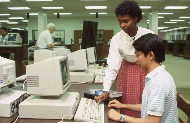 Library employee Melanie Thomas assists a student in the Todd Library’s CD-ROM center in this 1987 file photo.