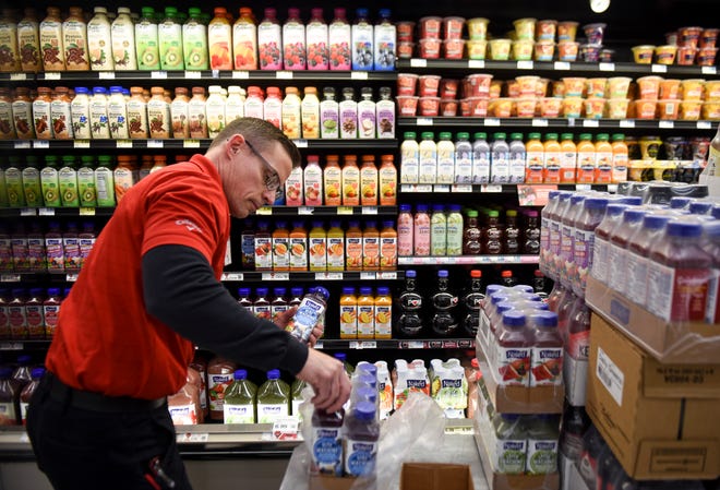 Produce and delivery worker Brian Binft stocks shelves on Thursday, Feb. 6, 2020 at the Hy-Vee on Minnesota Avenue. Hy-Vee recently announced a change in their stores hours and will no longer be open 24 hours. 
