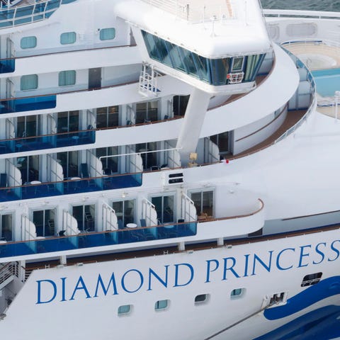 Some passengers are seen on the Diamond Princess a