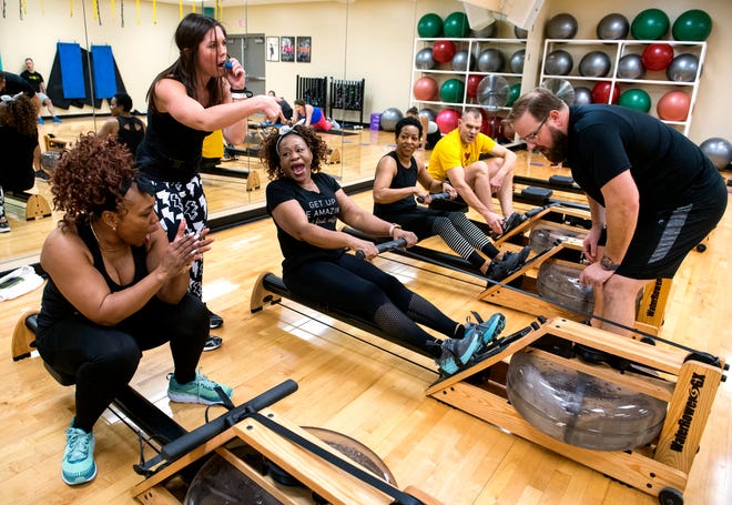 Trainer Jennifer Boester, second from left, instructs the class to encourage Sandra Bard, center, to finish her row in the Shockwave class during the Fit 4 All community fitness event at the Dunigan Family YMCA Saturday morning, Jan. 4, 2020. 