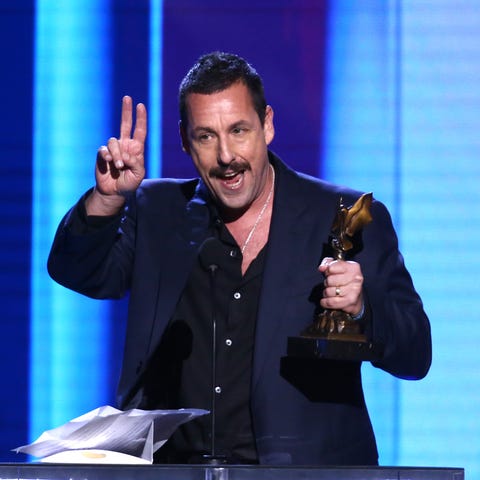 A day before the Oscars, Adam Sandler accepts the 