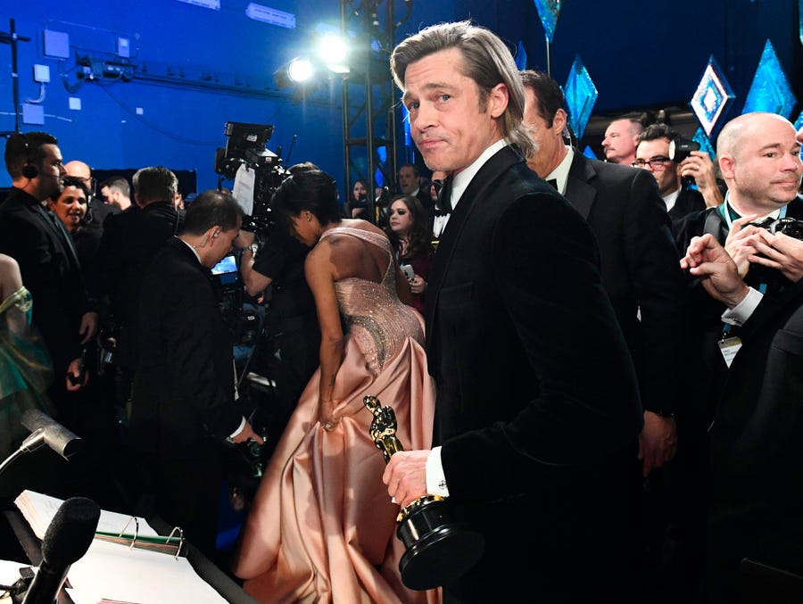 Brad Pitt looks on backstage at the 2020 Oscars after winning best supporting actor.