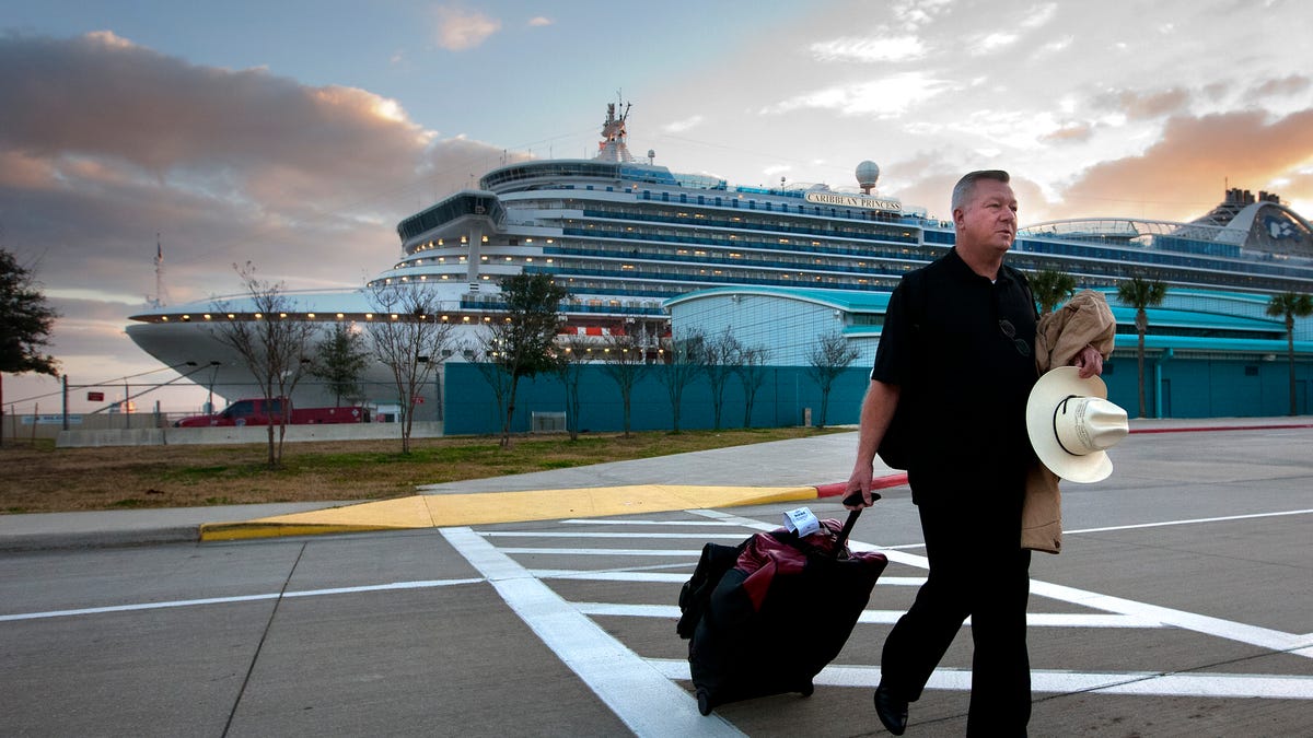 Jack Doebbler walks to his vehicle after getting off the Caribbean Princess cruise ship, Friday, Jan. 31, 2014, in La Porte, Texas.