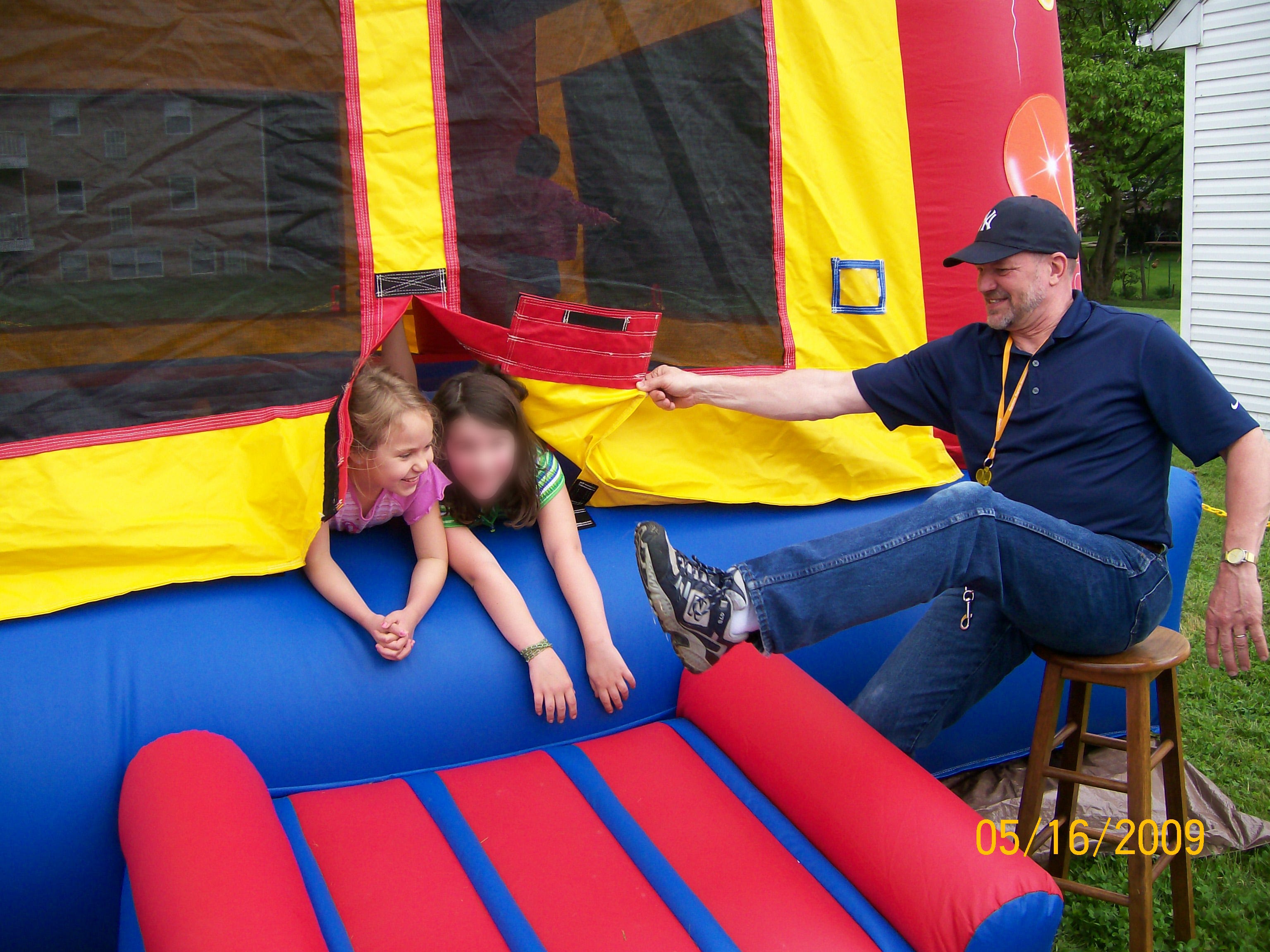 Anya Benninger and an unnamed friend play, under the watch of Donald Foose, at a community outreach event hosted by the church in 2009. The second girl's face has been blurred by USA TODAY to protect her anonymity.