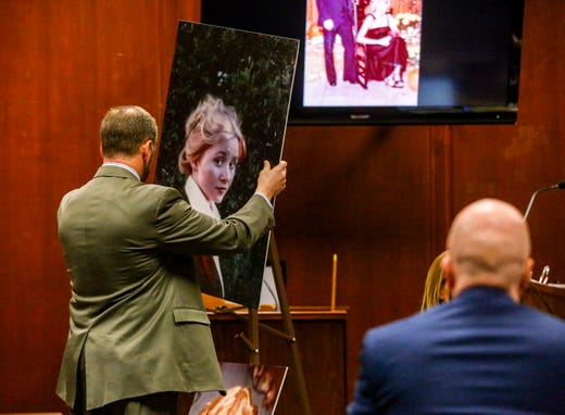 First Assistant Linn County Attorney Nick Maybanks places a photo of Michelle Martinko on a stand as he makes an opening statement during Jerry Burns' trial at the Scott County Courthouse in Davenport on Wednesday, Feb. 12, 2020.