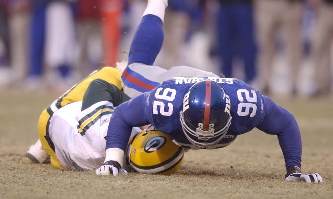 New York Giants Michael Strahan sacks Green Bay Packers quarterback Brett Favre to set an NFL season record for sacks during the fourth quarter of their game Sunday, January 6, 2002 at Giants Stadium in East Rutherford, N.J.