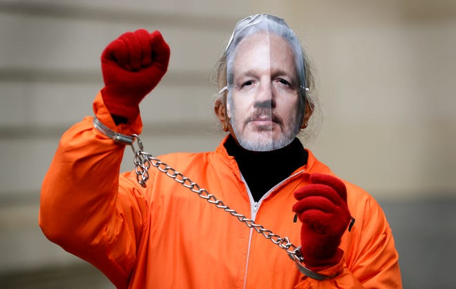 A demonstrator supporting Julian Assange wears a mask and chains outside Westminster Magistrates Court in London, on Jan. 23, 2020.
