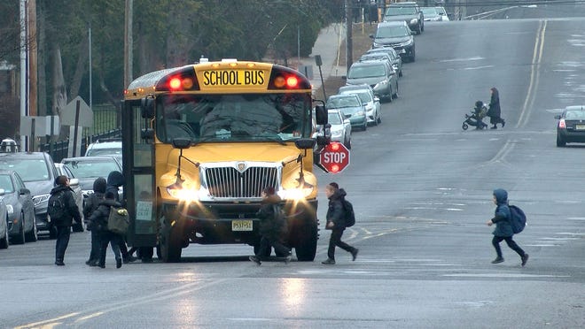 Students board a school bus along Forest Avenue in Lakewood.