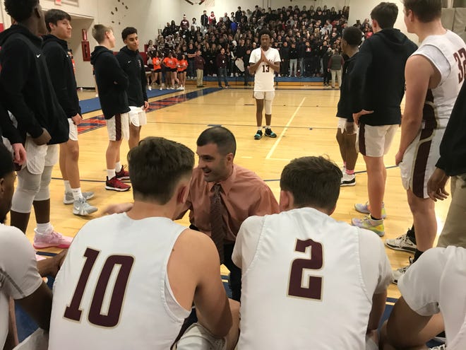 Arlington basketball coach Matt Hoyt talks with his players.
