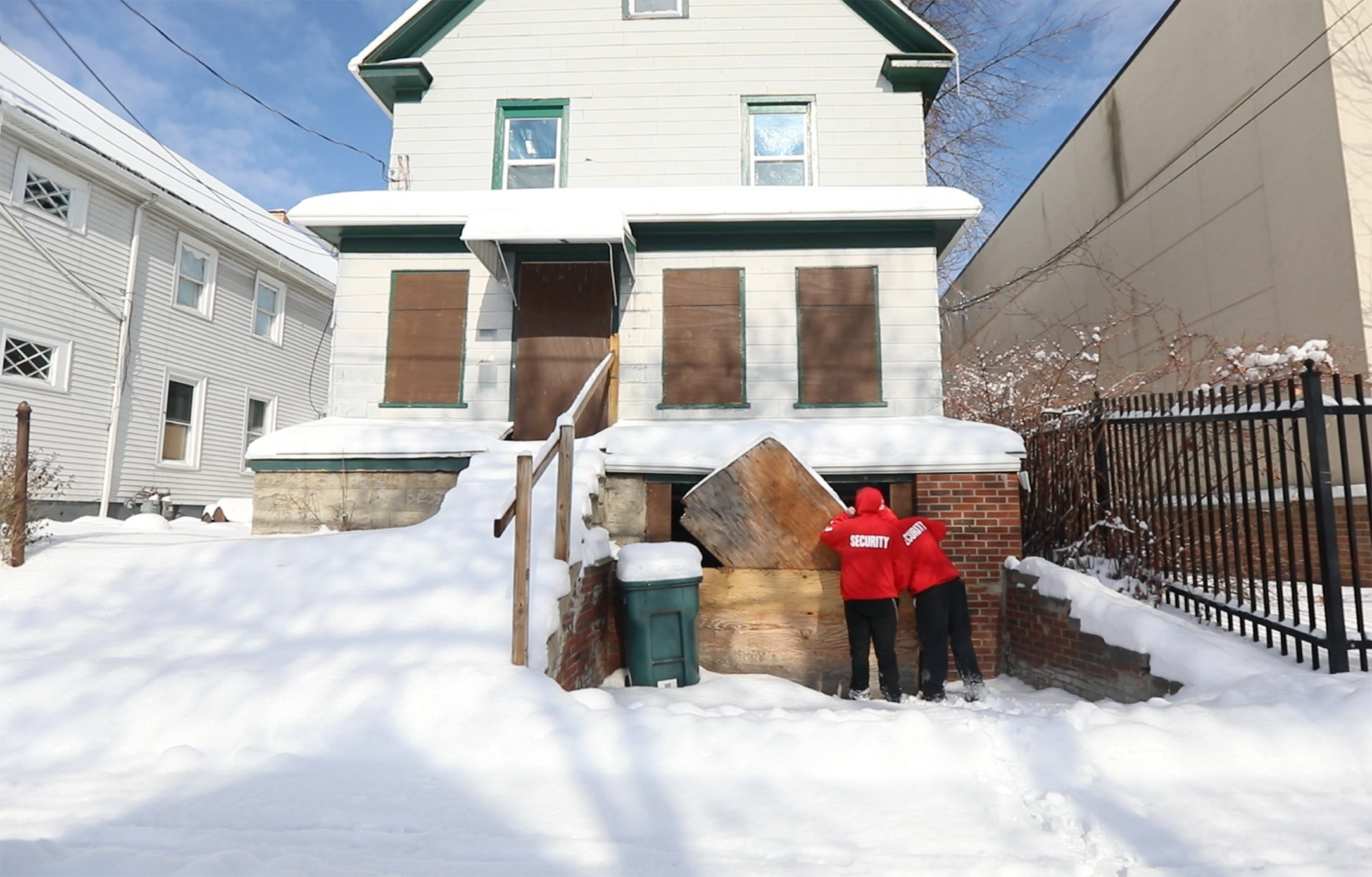 Gary Harding and Donny Huss, volunteers with Hope Dealers, check an abandoned house to see if there are signs of people going inside to live or use drugs.