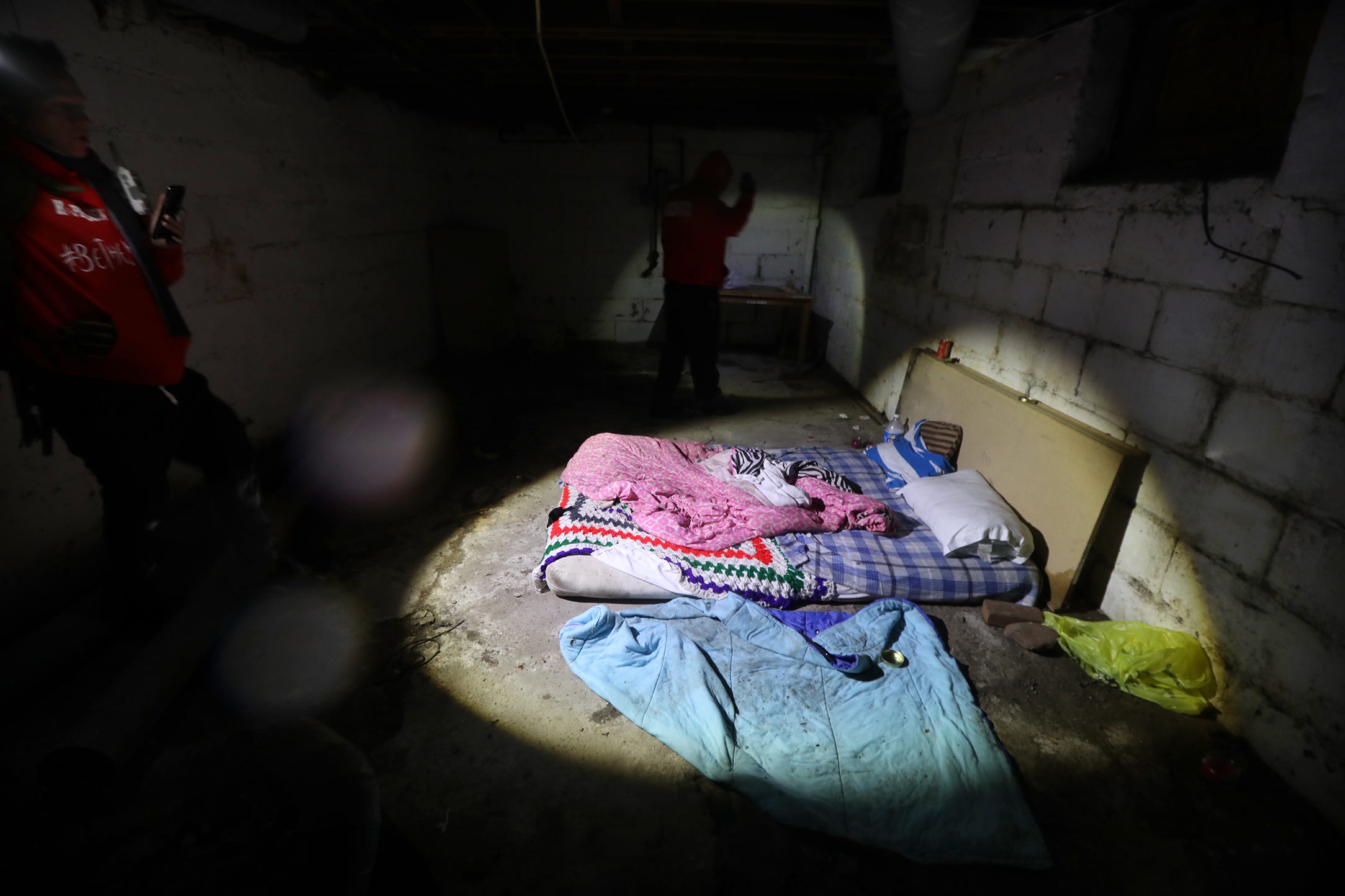 Gary Harding and Donny Huss, volunteers Hope Dealers, check an abandoned house for discarded needles and people that may need help.  When the volunteers go inside the home they do Facebook live for safety.  If something happens while they are inside, the volunteers watching Facebook outside the house can get help.  Harding and Huss found signs of someone living in the basement of this house.