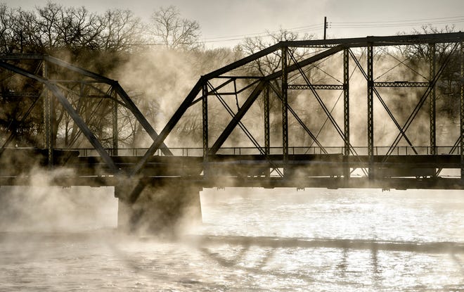 Steam fog rises from open water on the Mississippi River near the old Sartell bridge as temperatures hover around minus-18 on Thursday morning.